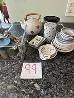 Overview of the set showing teapots, tea strainers, and teabag holders arranged on a counter.