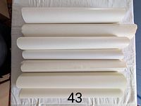 Rolled posters laid flat, showing edges and condition of paper