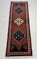 Full-length view of Persian runner rug laid flat, showing overall design and colors
