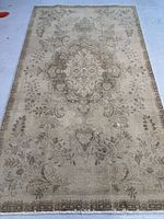 Full view of the antique washed Tabriz Persian rug showing overall pattern and condition