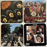 Top view of all four Beatles coasters showing different album cover artwork on each coaster.