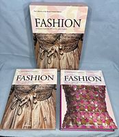Full set of two hardcover books with matching slipcase featuring a historical dress image on the front cover.