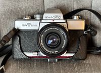 Front view showing Minolta SRT 200 camera with attached Minolta MD W.Rokkor-X 28mm f/2.8 lens, lens markings visible.