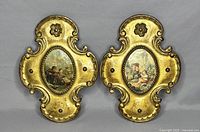Pair of two ornate gold-tone Florentine vintage plaques showing frontal view of both plaques side by side