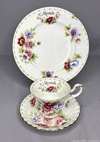 Front view of the March Anemones dessert plate, teacup, and saucer showing floral design and gold trim