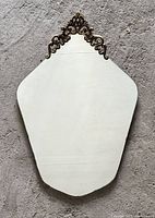 Full view of the vintage pentagonal mirror showing overall condition and shape.