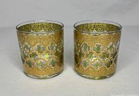 Two vintage Culver Valencia old fashioned glasses with 22k gold gild and emerald green diamond designs shown side by side on light background.