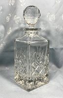 Front view of vintage lead crystal whiskey decanter showing intricate cut patterns and stopper.