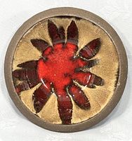 Top view of small round bowl with red and brown Fat Lava style glazing