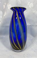 Front view of the cobalt blue glass vase showing swirl pattern and flared lip.