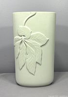 Front view of white porcelain bisque vase with embossed leaf pattern