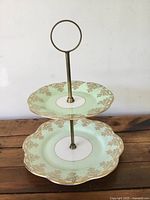 Side-angle photo of the two-tier fine bone china dessert stand, showing design and structure.