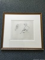 Full view of the matted and framed original engraving showing a woman holding a child, framed in a gold-tone wood frame.