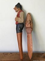 Two vintage hand-carved wooden page turners placed side by side, showing full length and detailed handles.