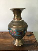 Full view of vintage Indian brass vase with enamel floral decoration, showing its shape and pattern.