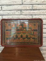 Full view of antique rectangular lacquered platter with detailed Middle Eastern architectural and figurative painting, showing wear and chips.