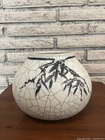 Front side of the vase showing bamboo leaf painted motif with crackle glaze.