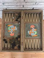 Full view of open backgammon board with playing pieces and dice placed on board points