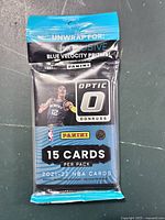 Front of sealed 2021 Panini Optic Donruss NBA basketball trading card pack showing Blue Velocity Prizms and player image