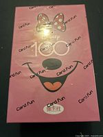 Front photo of sealed pink box with Minnie Mouse face and Disney 100 logo