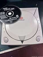 Top view of Sega Dreamcast console with NHL 2K game disc placed on top