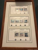 Framed collection of seven Canadian Group of Seven stamps in three rows with matching artist names and portraits