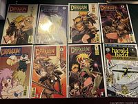 Eight Drakuun comic book issues arranged in two rows, showcasing fantasy-themed cover art including characters in armor and various action poses.