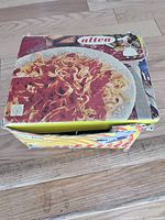 Full view of original box with pasta image on cover, worn and creased.