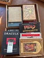 Top view of two boxes containing several books including Birdcraft, Weird Massachusetts, Dracula, Children's Stories from Indian Legends among others