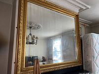 Full view of large mirror leaning against wall