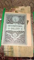 First photo showing the cover page of The International Gallery with decorative border and title text.
