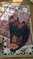 Photo showing three overlapping area rugs with different floral and leaf designs in natural light.