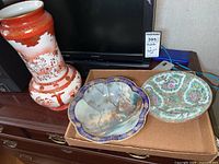 Overview of the lot showing the porcelain vase, Noritake bowl, and another patterned porcelain bowl on a wooden surface.