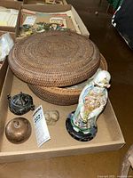 Photo of the whole lot showing woven basket, Asian figurine, metal pots, and monkey figurine.