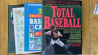 Four baseball books stacked showing titles and partial covers