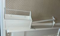 Photo showing both white painted wood wall pocket box and wall rack, highlighting their size and mounting holes.
