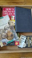 Four coin and antique collector's books in box showing covers and condition.