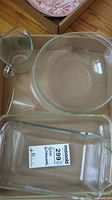 Pyrex large round glass mixing bowl and Pyrex clear rectangular glass baking dish seen together