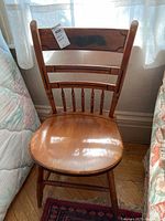 Single Hitchcock wood chair showing full front view, half spindle back, contoured wood seat, and legs with stretchers.