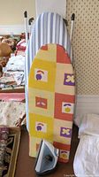 Ironing boards and iron setup showing cover patterns, iron in front