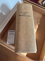 Fabric-bound spine of the vintage book titled 'Marks and Monograms'.