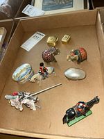 Box with two elephant-shaped pill boxes, two small rectangular pill boxes, and four painted soldier and jousting horse figurines