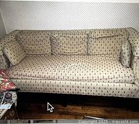 Full view of North Hickory sofa showing floral upholstered cushions and wooden legs.
