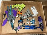 Overhead view of all nine Transformer figures and accessories in box
