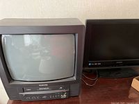 Toshiba 13 inch TV with integrated VCR visible from the front, showing screen and control buttons