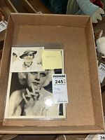 Two vintage Mary Pickford portrait photos laid in a box with a label indicating 'Vintage Photos' and lot number 245.