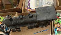 Top and side view of the vintage pressed steel locomotive showing domes and smokestack on the boiler and cab section