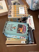 Boxed collection of VHS tapes including Lord Peter Wimsey, Jeeves & Wooster, and several classic film titles.