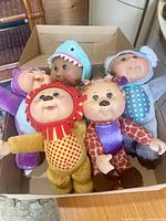 Top view of five Cabbage Patch Animal Cuties dolls in a box showing front faces and animal costumes