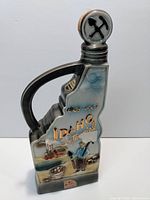 Front view of the Jim Beam Idaho Centennial decanter showing the mining scene with '1863-1963 Idaho Centennial' gold lettering.
